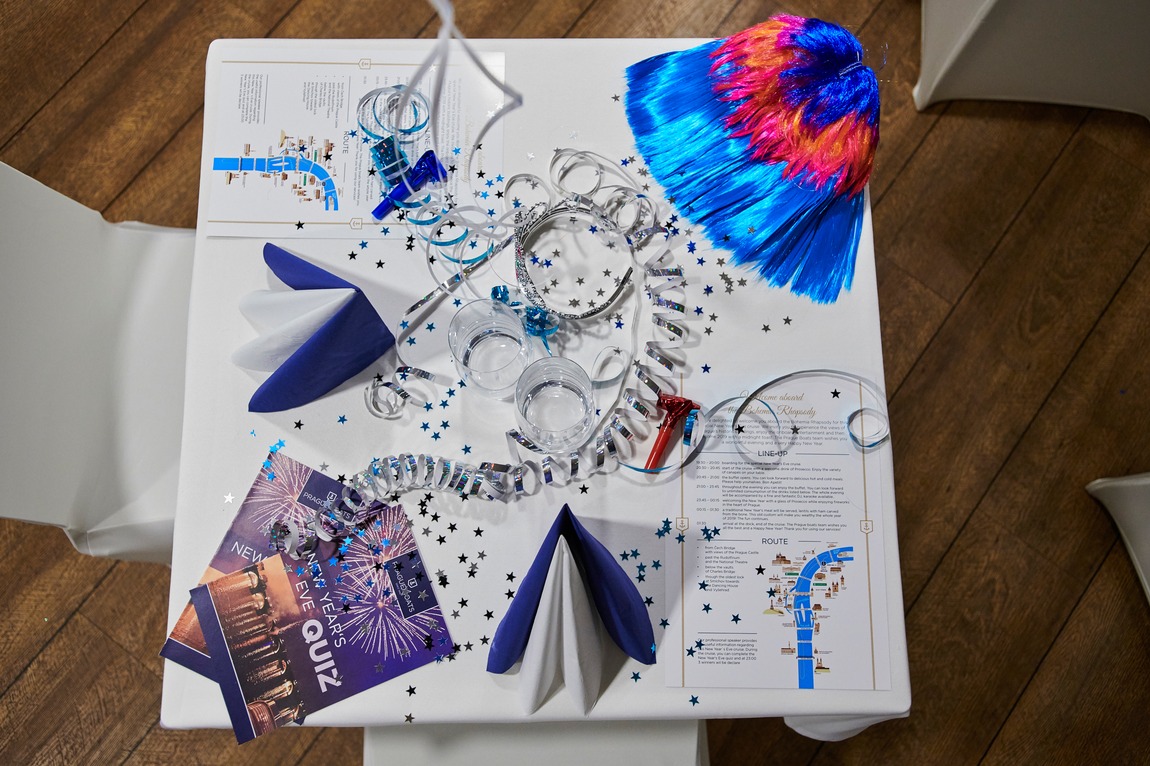 New Year’s Eve table with streamers, blue napkins and the menu